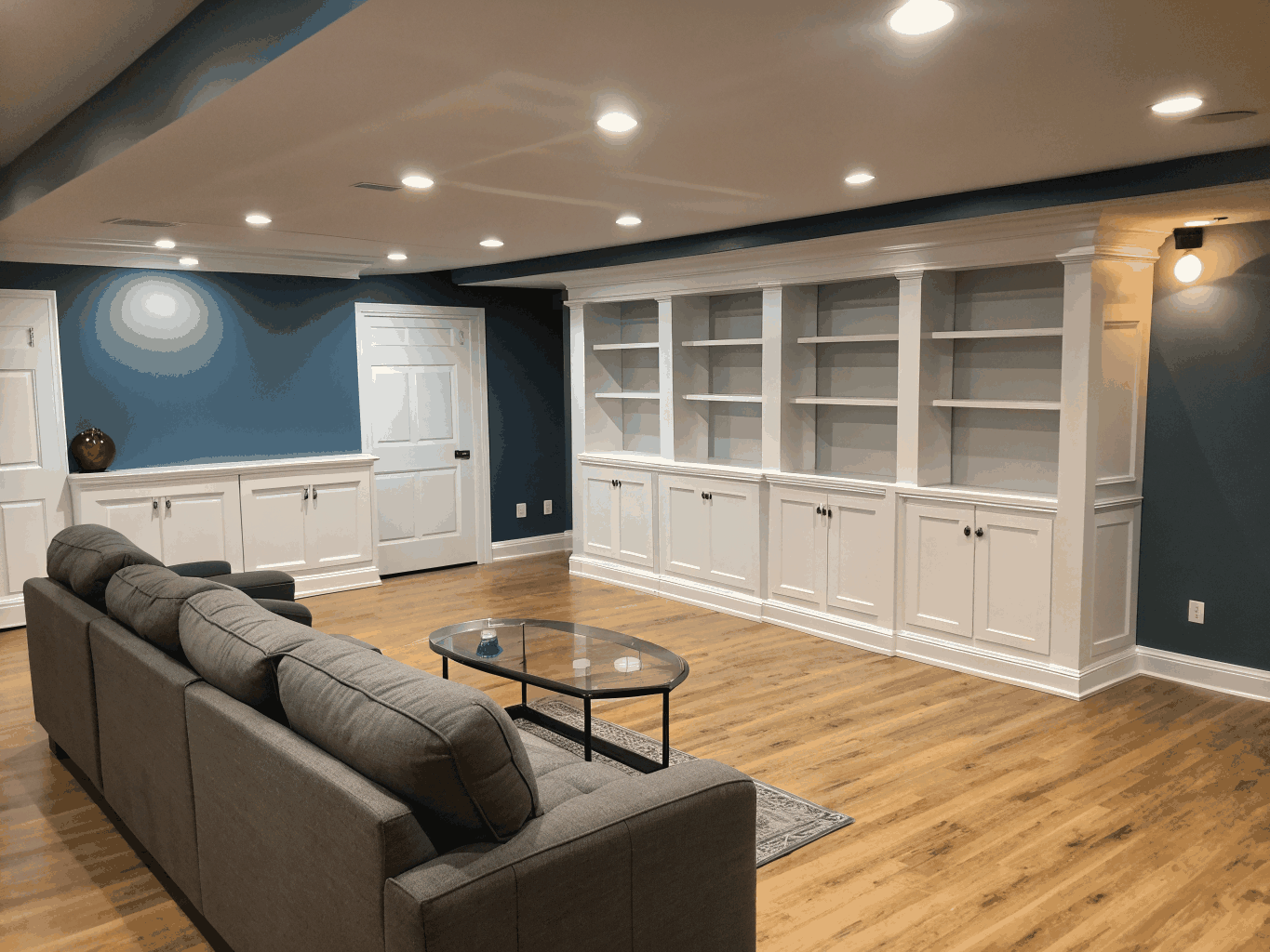Finished basement living room layout with recessed lighting and high ceilings in Brookhaven