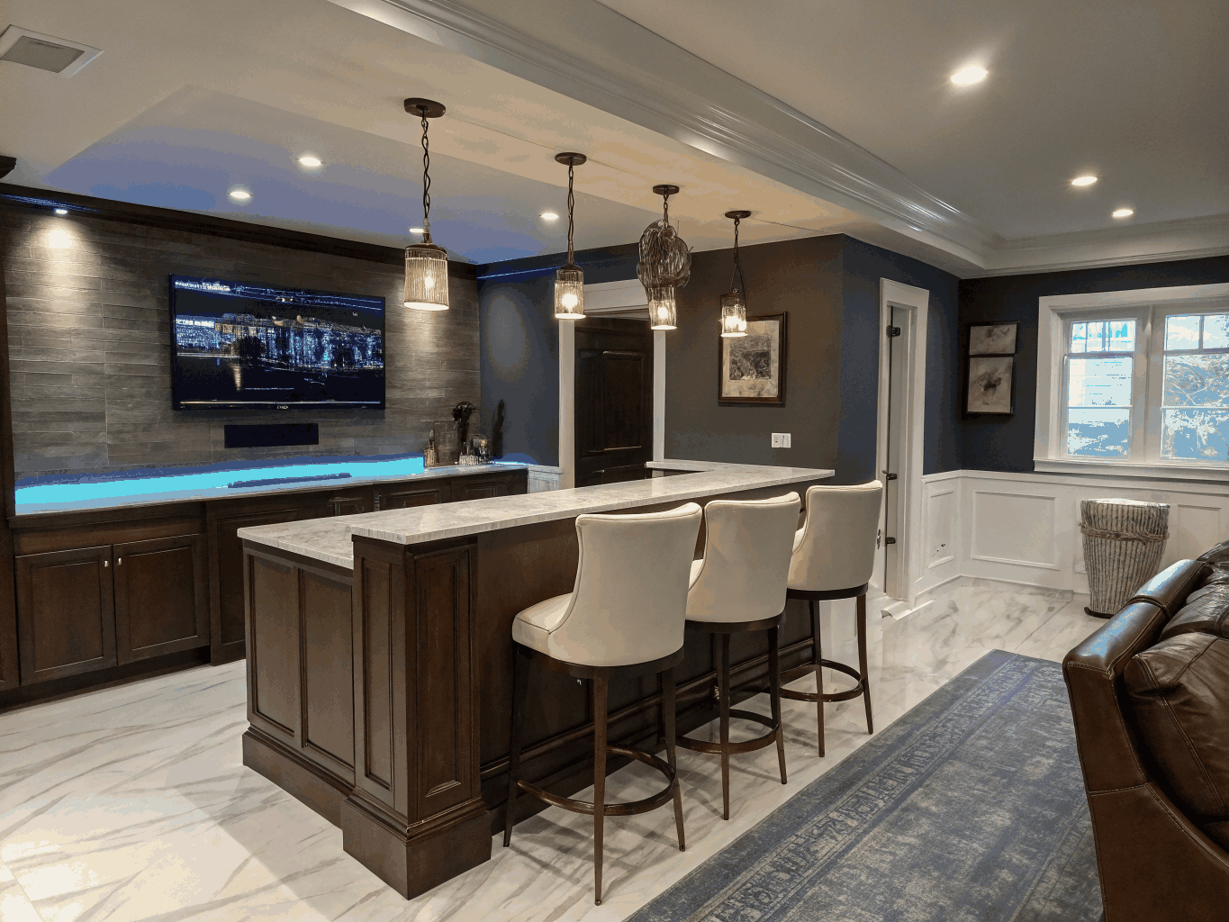 Finished walkout basement with recessed lighting, custom wine bar, and comfortable lounge area