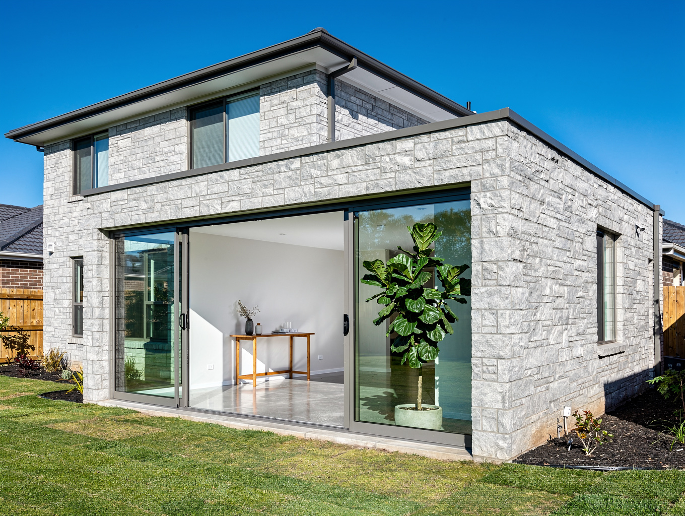 Finished residential home addition with custom architectural windows and seamless exterior transition