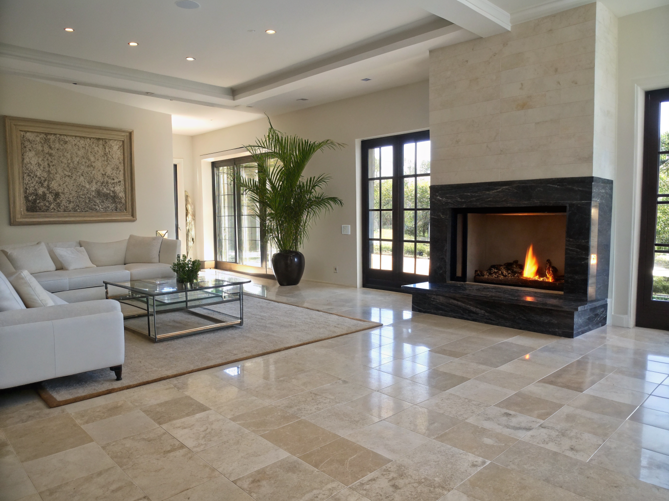 Spacious renovated family living room featuring floor-to-ceiling fireplace hearth and bespoke millwork