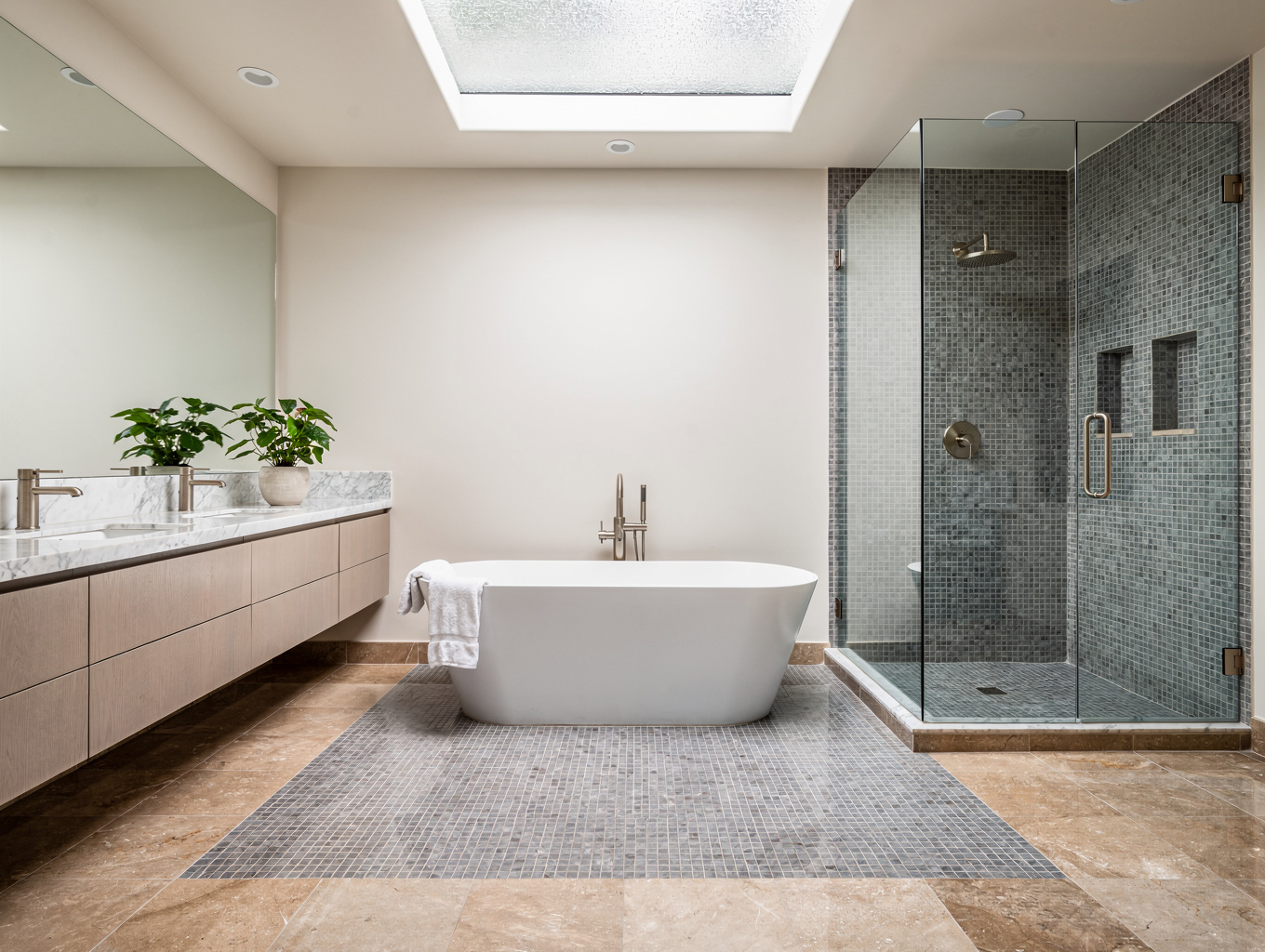 Modern luxury master bathroom with marble tile walk-in shower and freestanding soaking tub