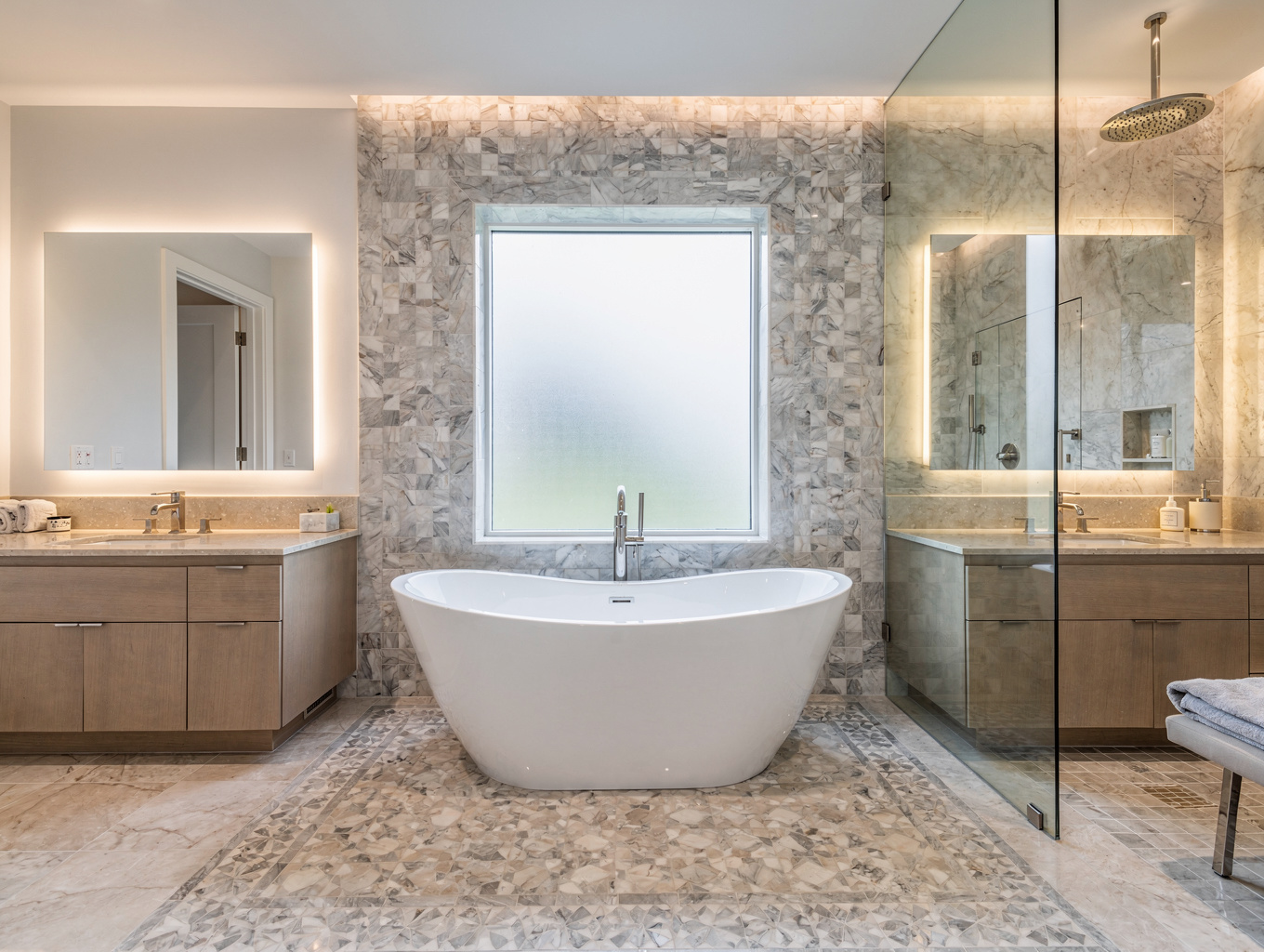 Luxury master bathroom suite with freestanding tub and glass walk-in shower enclosure
