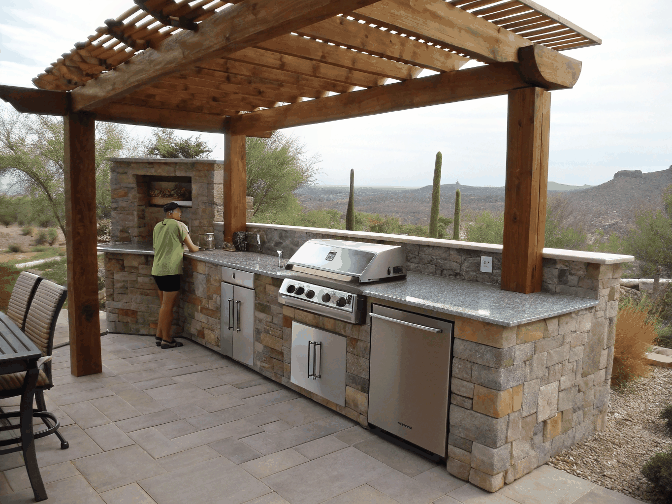 Custom built outdoor kitchen island with granite countertops and stainless appliances